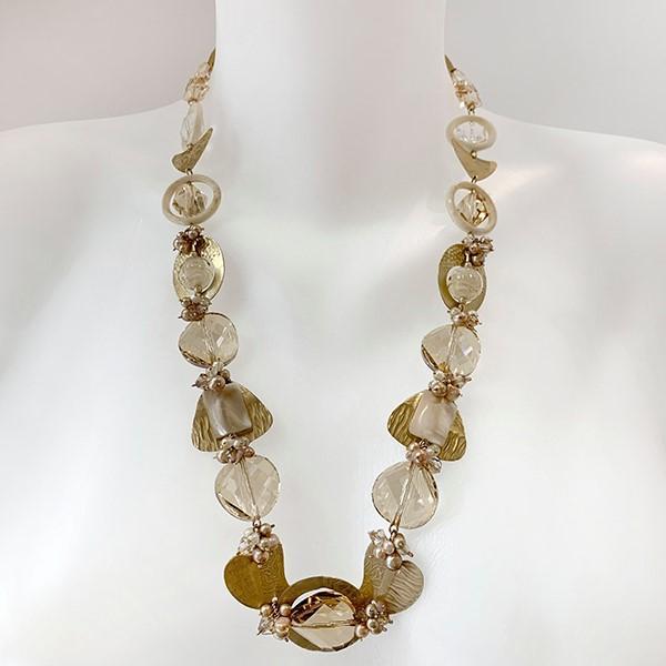 This unique pearl and crystal necklace is made from hand worked brass, Austrian crystals, freshwater pearls and glass. The necklace features many chain links and beads of different shapes and materials running along the necklace.