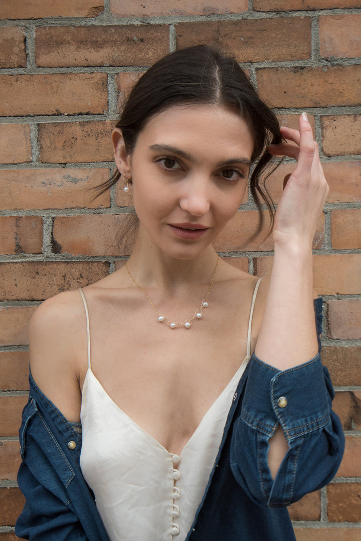 This filled gold chain necklace with pearls has been made by combining tear drop shaped links made from white freshwater pearls strung through gold fill wire. These links are connected to form this pearl, chain link necklace.