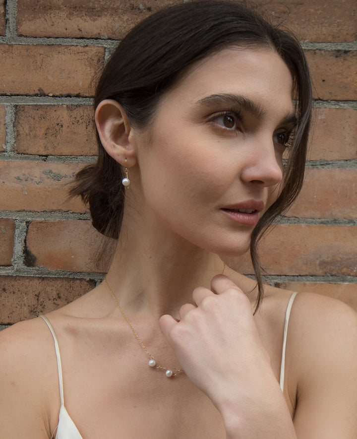 These pearl drop earrings are made from sterling silver and fresh water pearls. They have silver hooks and large, white pearl dangles.