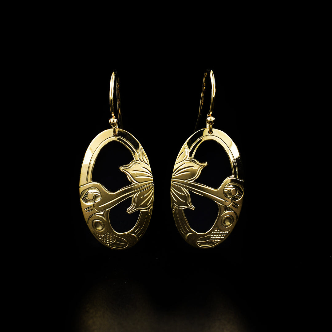 These 14K Gold Oval Hummingbird Earrings are hand carved by Kwakwaka'wakw artist Harold Alfred.  The design depicts a hummingbird drinking from the flower. The earrings measure 1.5" x 0.63".