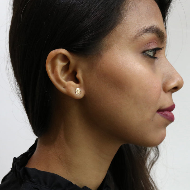These Wolf earrings are made from 14K gold and are small and circle shaped. There are depictions of the Wolf carved into the surface of these stud earrings.