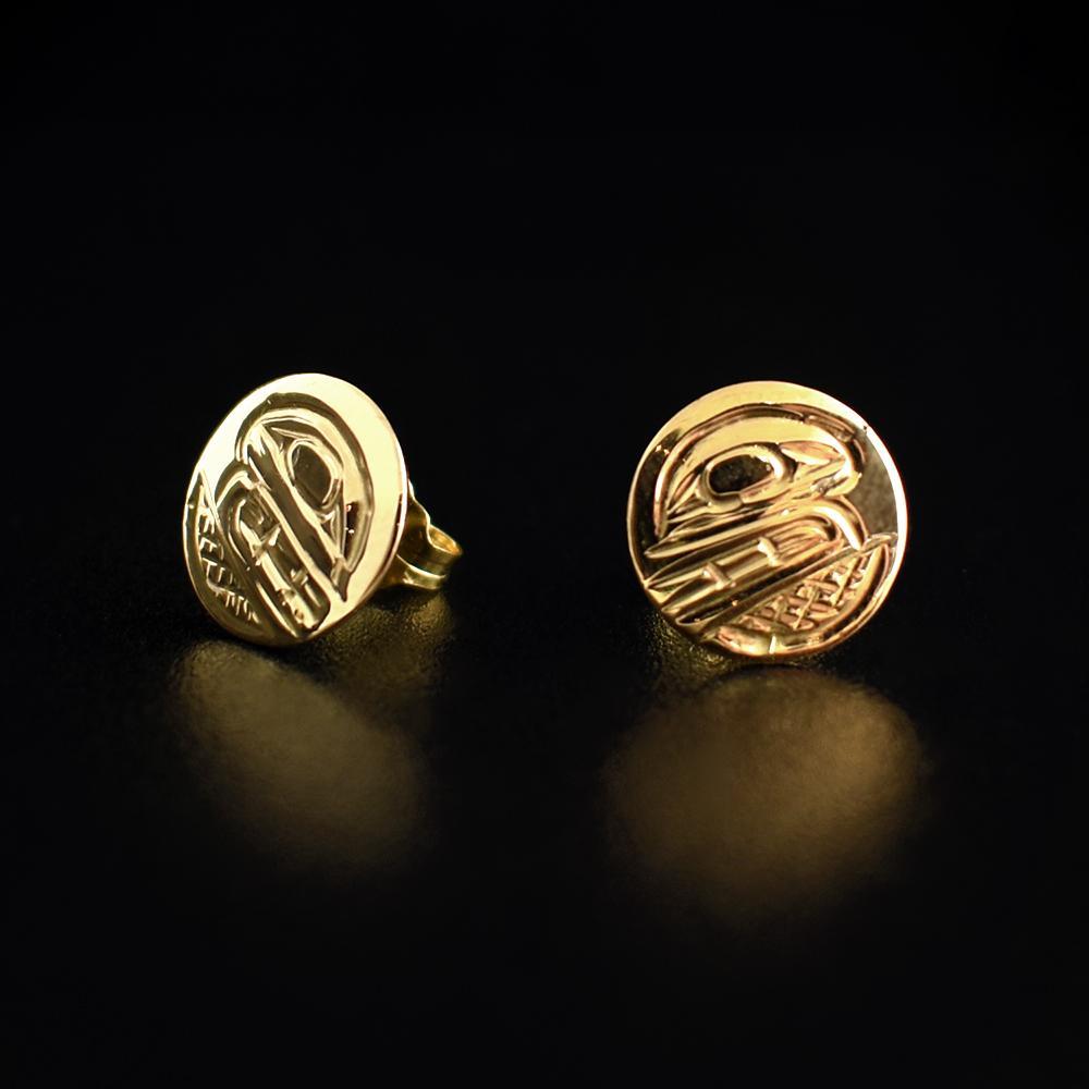 These 14K gold stud earrings are small and circle shaped. There are depictions of the Orca carved into the surface of the earrings