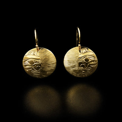 14K Gold Florentine Moon Earrings by Harold Alfred. Each earring depicts half of a moon's face on half of the earring. The other half of each earring the artist has hand carved delicate, straight lines going horizontally across. He has done this to create a contrast effect and to allow for the face of the moon to stand out.