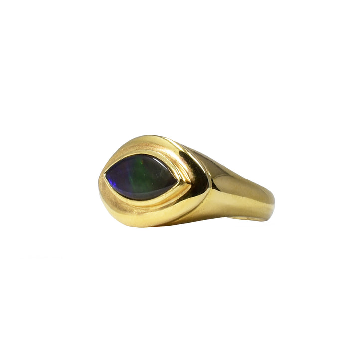 Unique ammolite eye signet ring by Korite. A piece of grade AA ammolite has been bezel set in a 14K gold signet ring. Stone shines a variety of lovely colours, featuring purple, blue, green, orange and red. Size 7.