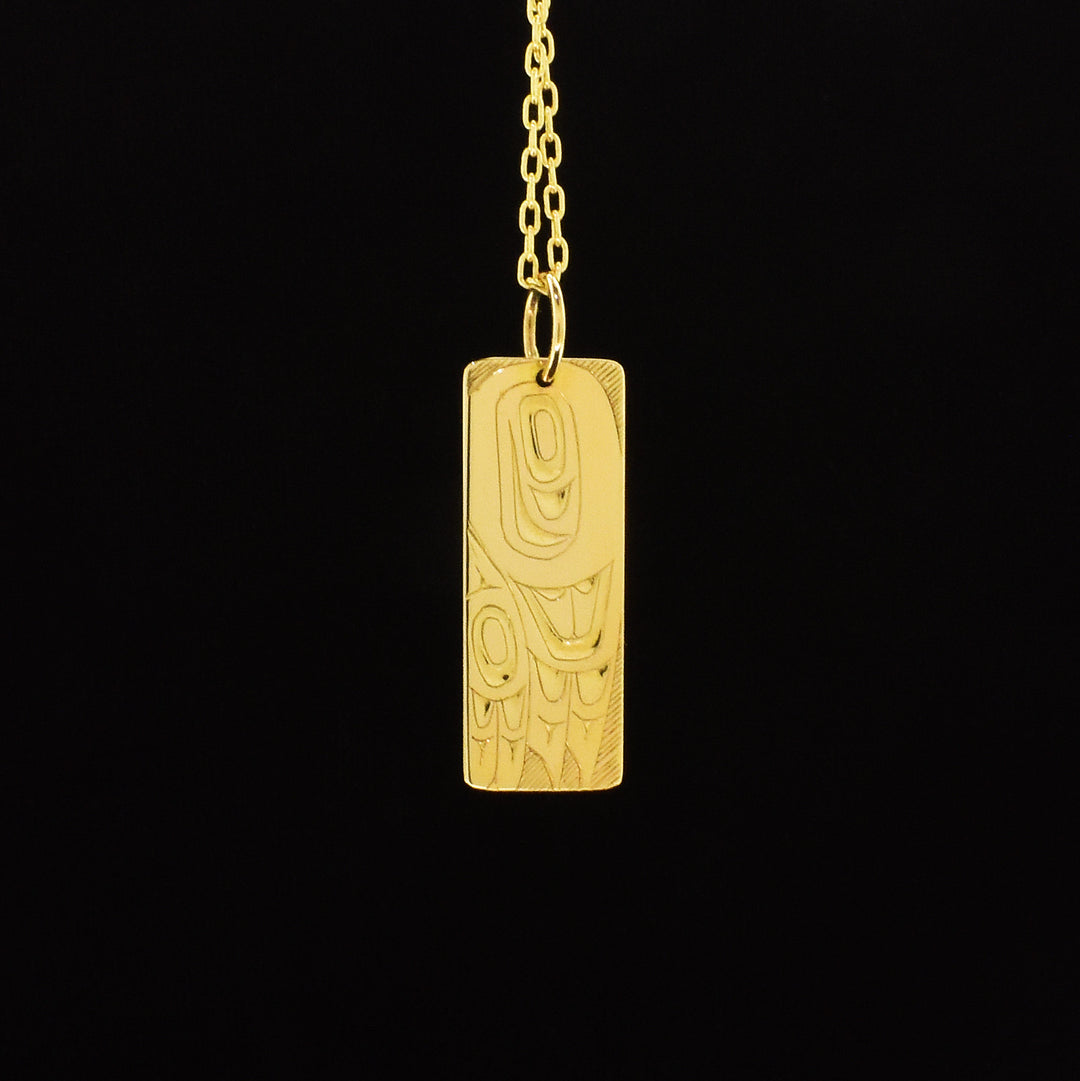 14K gold rectangular eagle wing pendant hand-carved by Indigenous artist Andrew Williams. Pendant is 1.25" x 0.38" with bail. Chain not included.