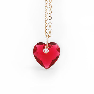 14K Gold Fill Red Swarovski Crystal Heart Necklace handcrafted by artist Debra Nelson. Both red heart and small bead hanging from bail are Swarovski Crystal. Pendant measures 0.67" x 0.60" including bail. Chain is 18" long.