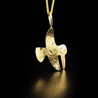 Delicate flying hummingbird pendant hand-carved by Tlingit artist Fred Myra. Made of 14K yellow gold. Pendant measures 1.2" x 0.6" including bail. Chain not included.