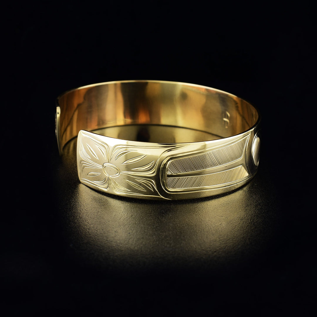 Hummingbird cuff bracelet hand-carved by Haisla artist Hollie Bartlett. Made of 14K gold. Bracelet is 6.25" long with 0.56" gap and has width of 0.50". The Hummingbird Legend Represents: BEAUTY, LOVE, HARMONY