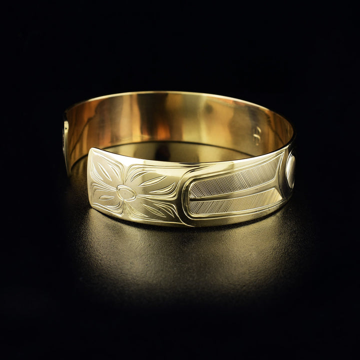 Hummingbird cuff bracelet hand-carved by Haisla artist Hollie Bartlett. Made of 14K gold. Bracelet is 6.25" long with 0.56" gap and has width of 0.50". The Hummingbird Legend Represents: BEAUTY, LOVE, HARMONY