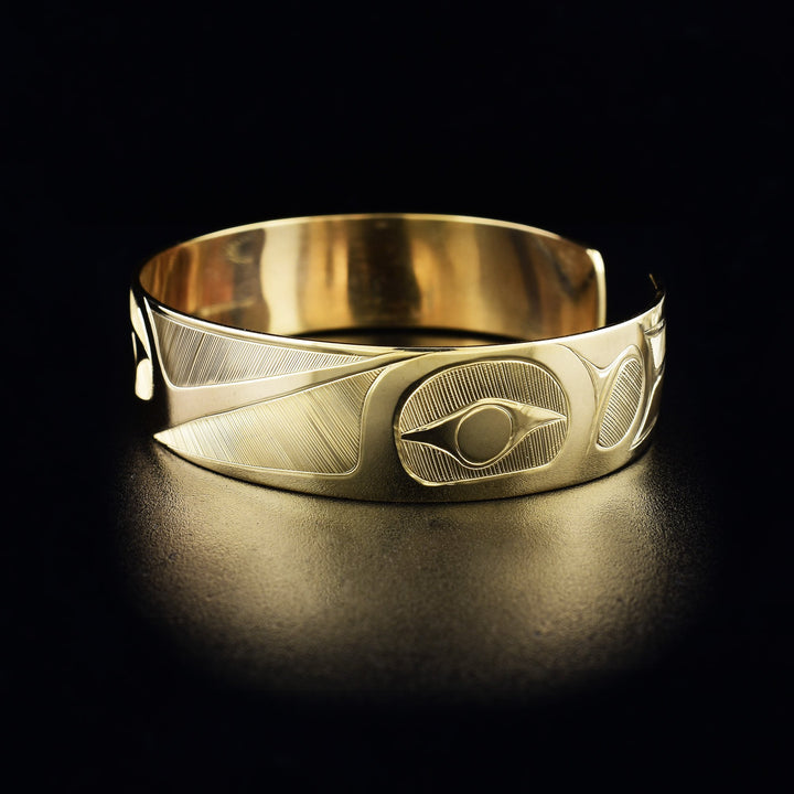 Hummingbird cuff bracelet hand-carved by Haisla artist Hollie Bartlett. Made of 14K gold. Bracelet is 6.25" long with 0.56" gap and has width of 0.50". The Hummingbird Legend Represents: BEAUTY, LOVE, HARMONY