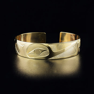 Hummingbird cuff bracelet hand-carved by Haisla artist Hollie Bartlett. Made of 14K gold. Bracelet is 6.25" long with 0.56" gap and has width of 0.50". The Hummingbird Legend Represents: BEAUTY, LOVE, HARMONY