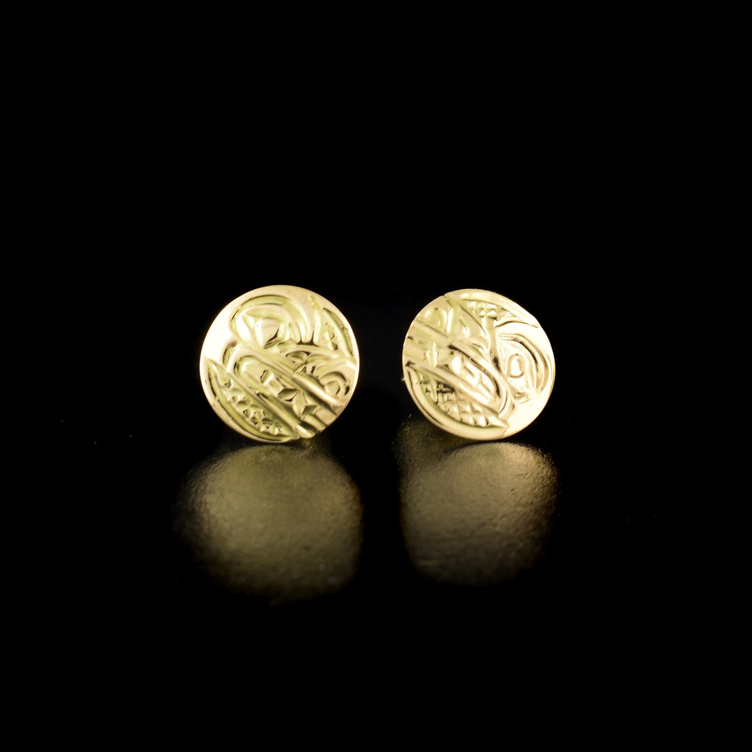 Wolf stud earrings hand-carved by Kwakwaka'wakw artist Carrie Matilpi. Made of 14K gold. Each earring is 0.38" in diameter.