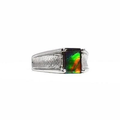 Gold ammolite ring by Korite. A dazzling rectangle of grade A ammolite is set in a 14K white gold ring. Stone shines mainly orange, green and blue. Band has a cross-hatching pattern along front, giving ring a unique look. Size 6.