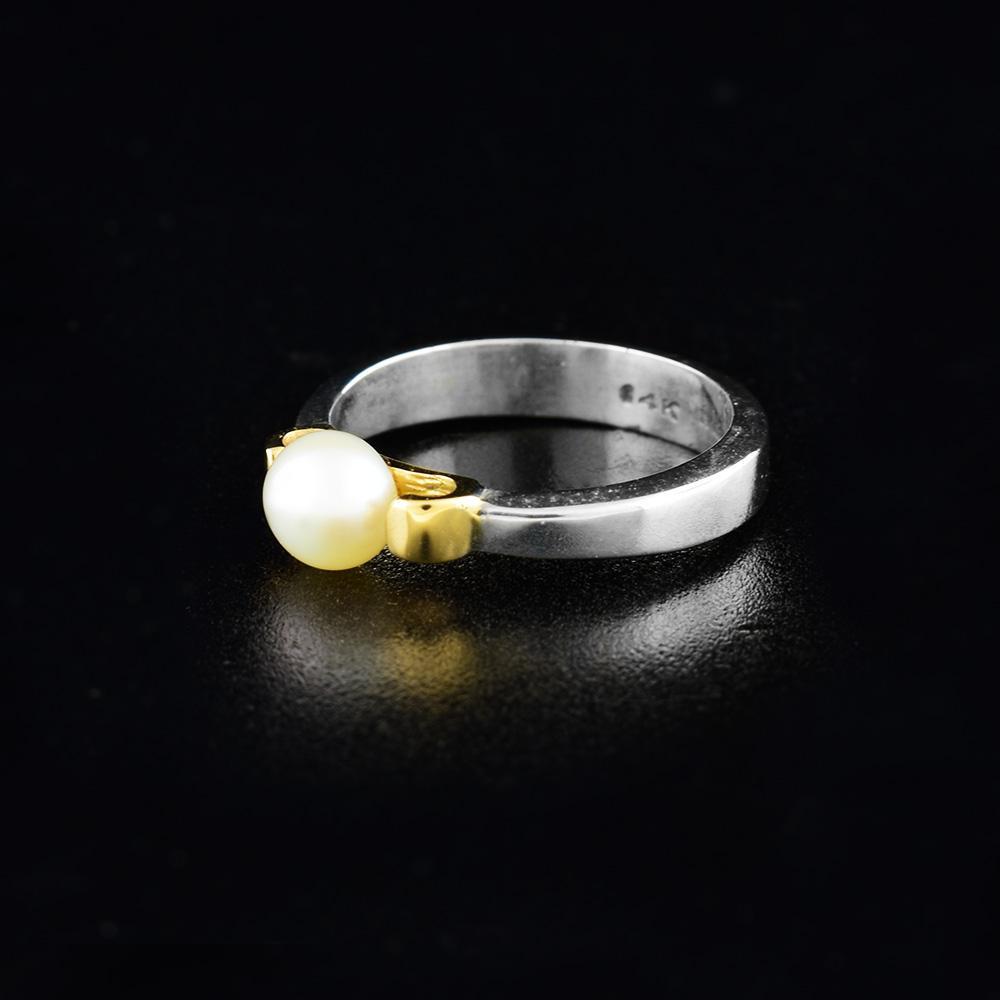 This sterling silver and 14K gold pearl ring has a thin silver band and a freshwater pearl set on a gorgeous, gold bezel.