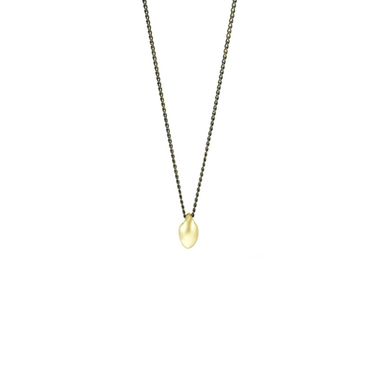 18K Gold Seed Pendant Necklace handcrafted by artist Dushka Vujovic. She has used solid 18K gold for the seed pendant. Oxidized sterling silver chain included. Pendant measures 0.38" x 0.19". Chain is 20" long.
