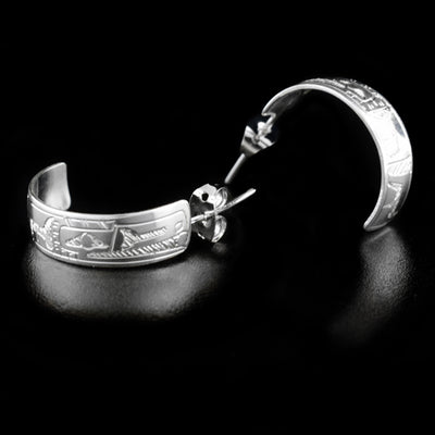 These 1/4" Raven Hoop Earrings are hand-carved from sterling silver by Coast Salish artist Gilbert Pat.  Each earring measures 0.75" x 0.25".     The Raven Legend Represents: CREATIVITY, MISCHIEF, MAGIC.
