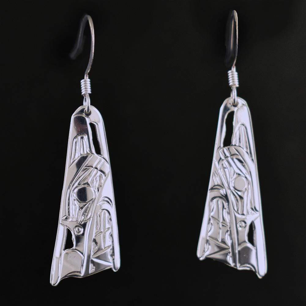 These dangling Wolf earrings are made from sterling silver and have wide, tapered hangs. There are cutouts and carvings on the surface of the hangs that depict the Wolf.
