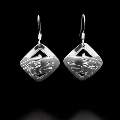 Sterling Silver Diamond Shaped Eagle Earrings by Harold Alfred. The design depicts the head of an eagle with a large beak pointing downward. Small parts of the earring are cutout.