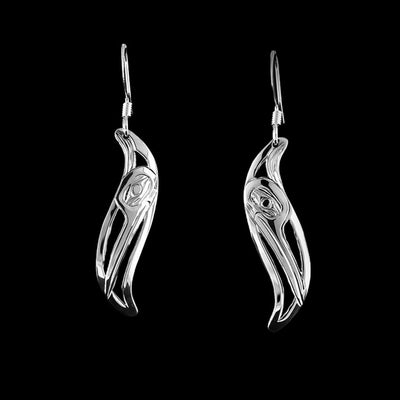 Sterling Silver Leaf Style Hummingbird Earrings by Harold Alfred. Each earring is shaped like a leaf. The artist has hand-carved the profile of a hummingbird's head in each earring facing downward. The hummingbird has a small head and a long, narrow beak. The background has been cut out.