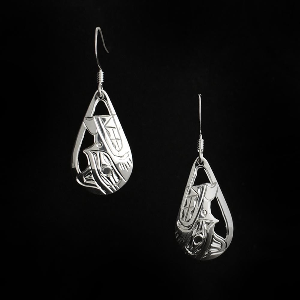 These Wolf earrings are made from sterling silver and have teardrop shaped earrings. The hangs have cutouts and carvings on the surface of them that depict the Wolf.