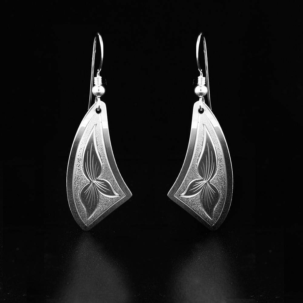 These triangle dangle earrings are made from sterling silver and have curvy triangular hangs. There are floral designs made on the surface of the hangs.