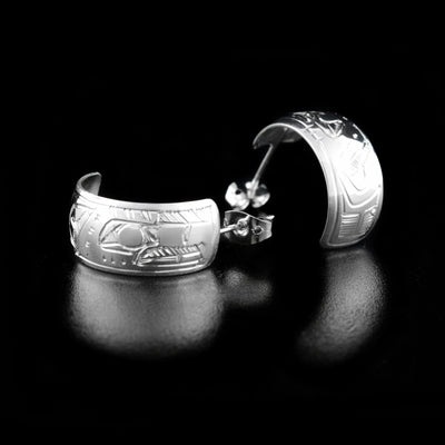 Sterling Silver 3/8" Eagle Hoop Earrings by Jeffrey Pat. The artist has hand-carved the profile of an eagle's head at the top of the hoop. The rest of the earring has intricate designs representing the body and feathers of the eagle.