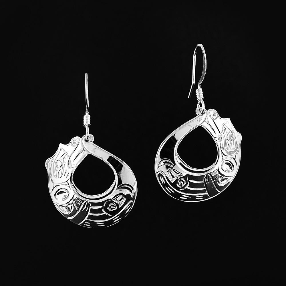 These dangling Otter earrings are made using sterling silver and have round hangs with a circle cutout in the center of them. The hangs have carvings on the surface of them depicting and are shaped like an Otter curled on its back.