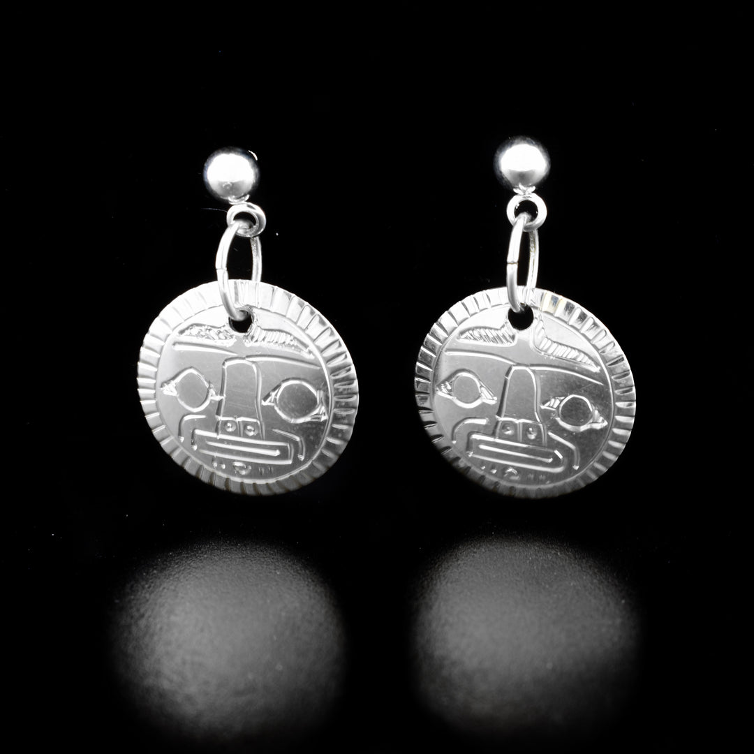 These dangling Moon earrings are made from sterling silver and have small, circle shaped hangs. There are carvings on the surface of the hangs depicting the Moon.