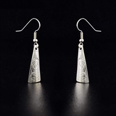 Sterling Silver Tricorner Wolf Earrings by Jeffrey Pat. Each earring is in the shape of a triangle. The artist has hand-carved the profile of a wolf's head facing downward. The wolf has a pointy ear on the back of its head and sharp teeth showing.