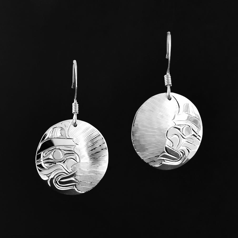 These Moon earrings are made from sterling silver and have circle shaped hangs. There are depiction of the half Moon carved into the surface of the hangs.