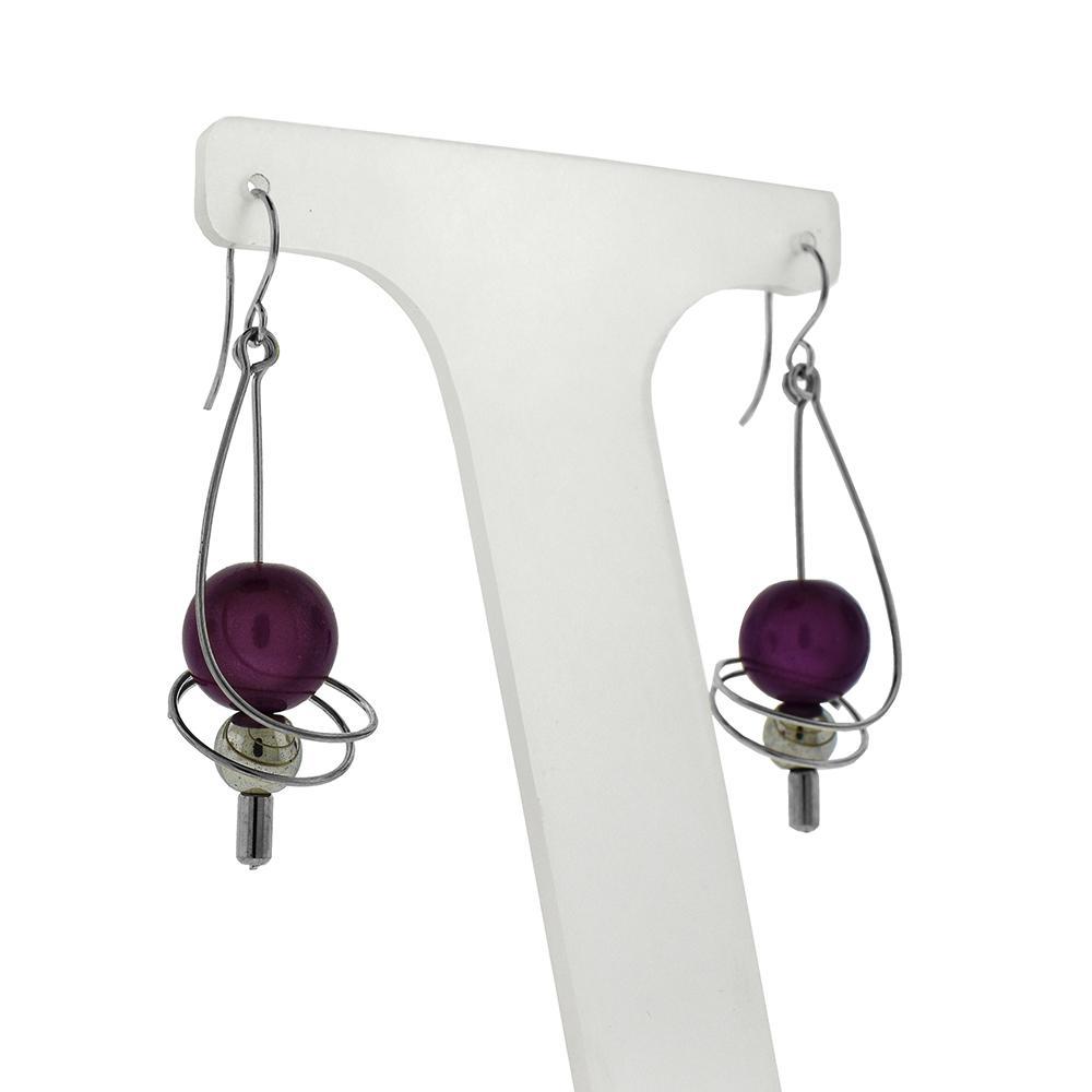 These dangle bead earrings are made from sterling silver wire that has been spiraled to hold interchangeable different colored beads.