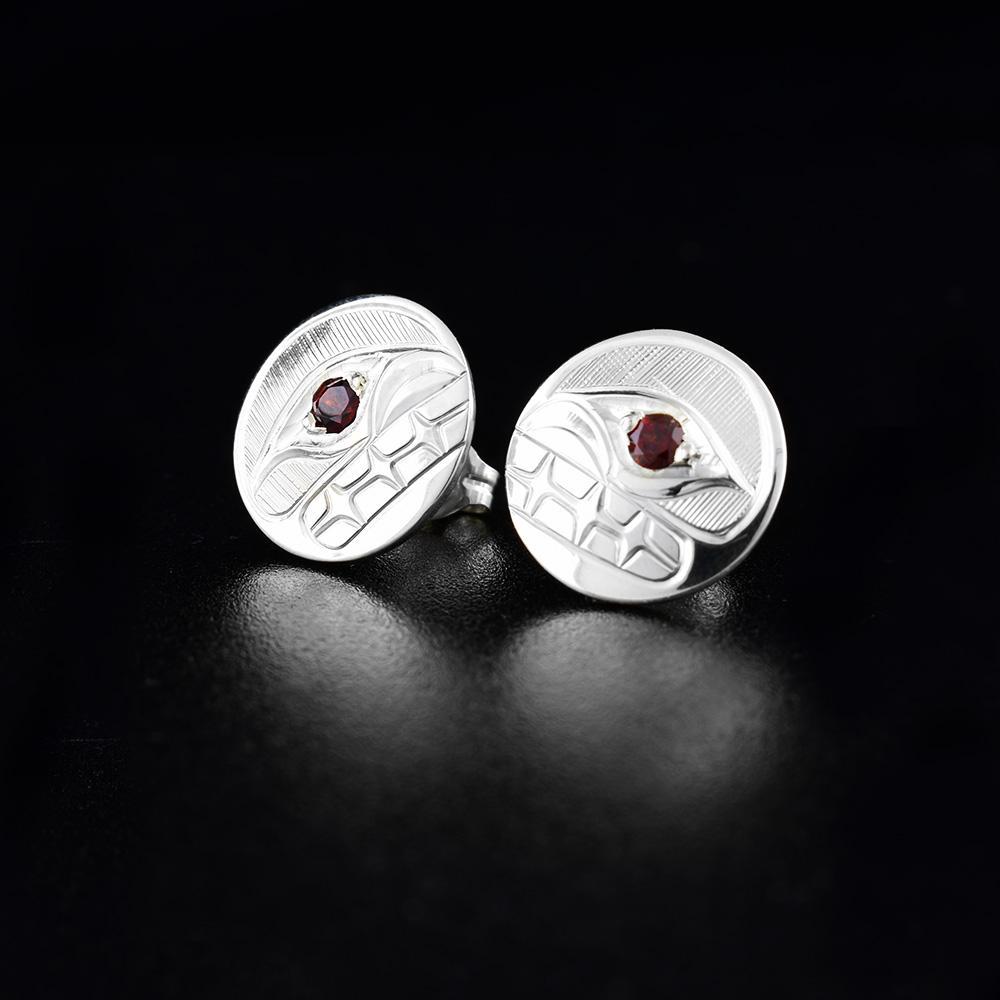 These sterling silver stud earrings hold the shape of the Orca with garnet stone eyes. Both earrings measure 1/2" in diameter.
