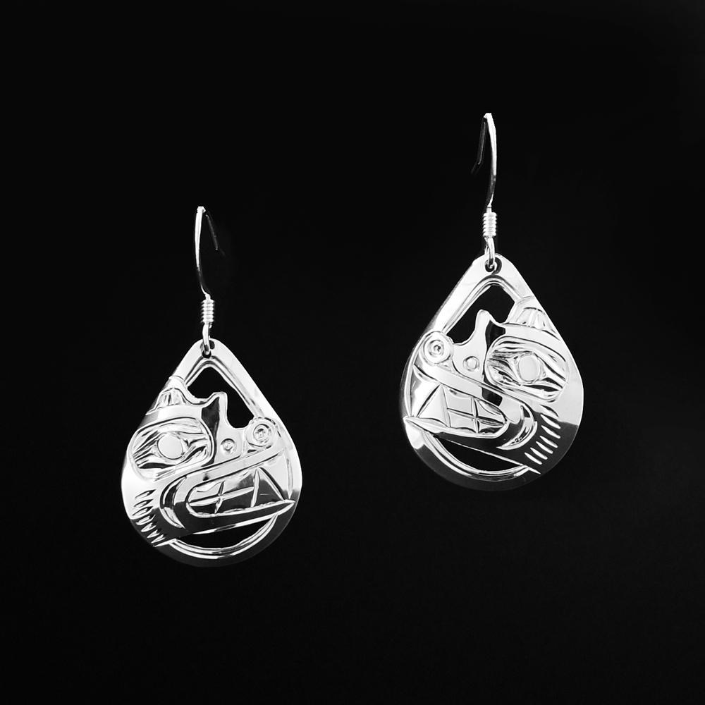These sterling silver teardrop earrings have small, cutout hangs. There is a depiction of the Bear carved into the hangs, the cutout designs go around the Bear.