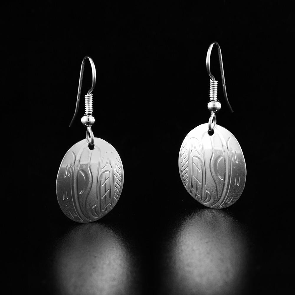 These sterling silver Orca earrings have oval shaped hangs with depictions of the Orca carved into the surface of them.