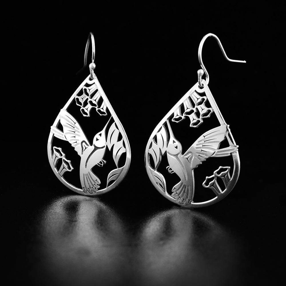 These sterling silver dangle earrings have teardrop shaped hangs with cutout designs that depict the Hummingbird.