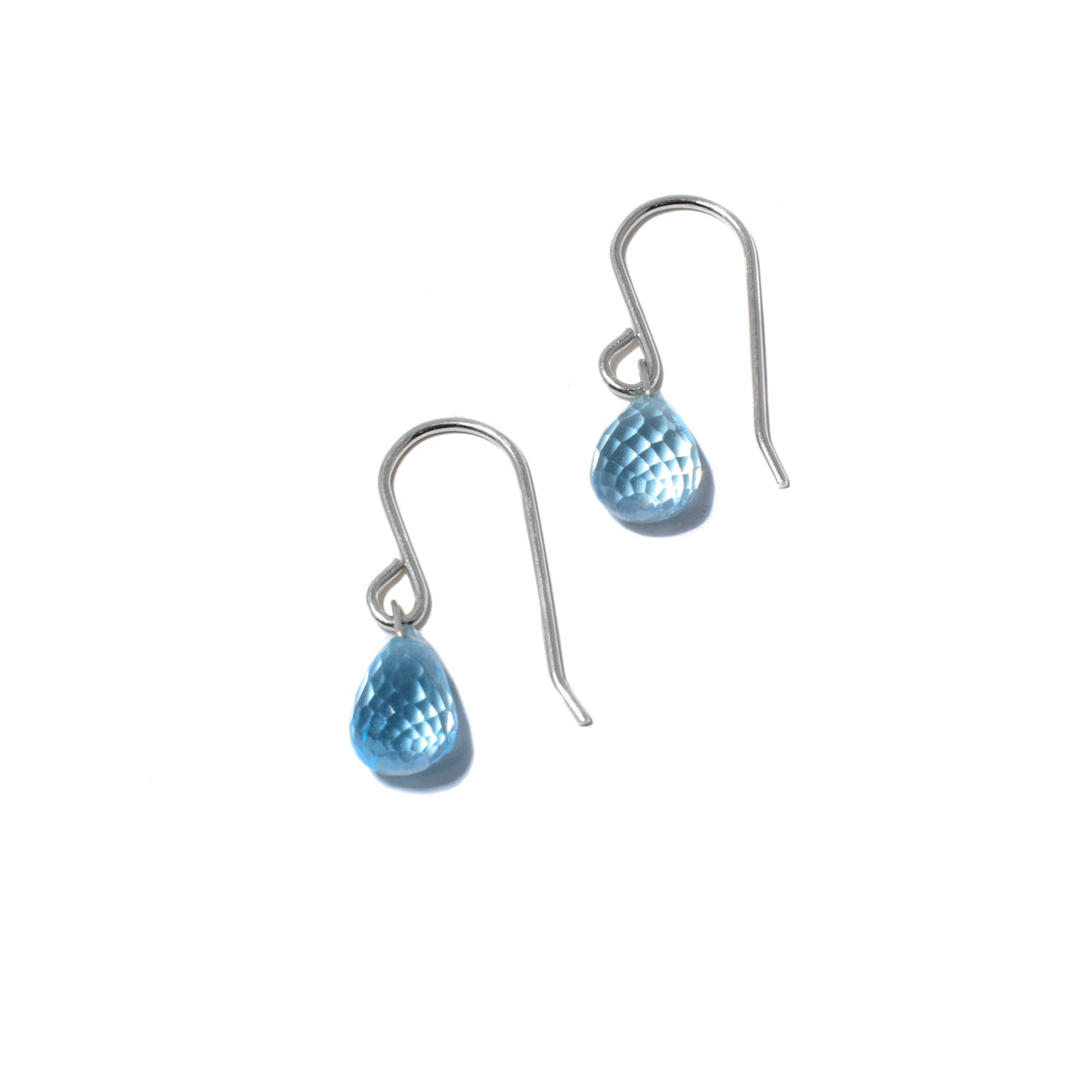 These teardrop topaz earrings are made from sterling silver and blue topaz gemstones. The hooks are sterling silver and there are beautifully cut, teardrop shaped gems dangling from them.
