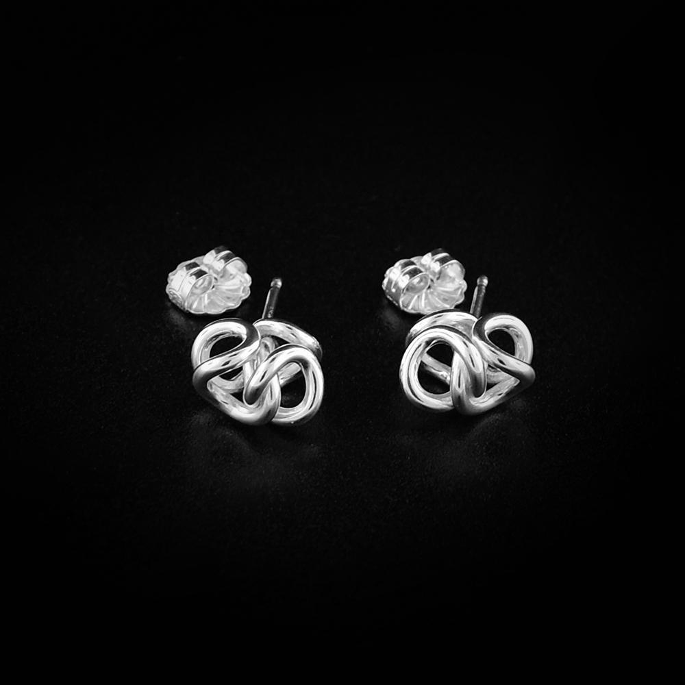 These dainty stud earrings are made from sterling silver and are made up of interlocked hoops that represent a hug.