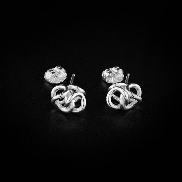 These dainty stud earrings are made from sterling silver and are made up of interlocked hoops that represent a hug.