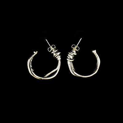 Sterling Silver Twist of Fate Small Hoop Earrings handcrafted by artist Joy Annett.