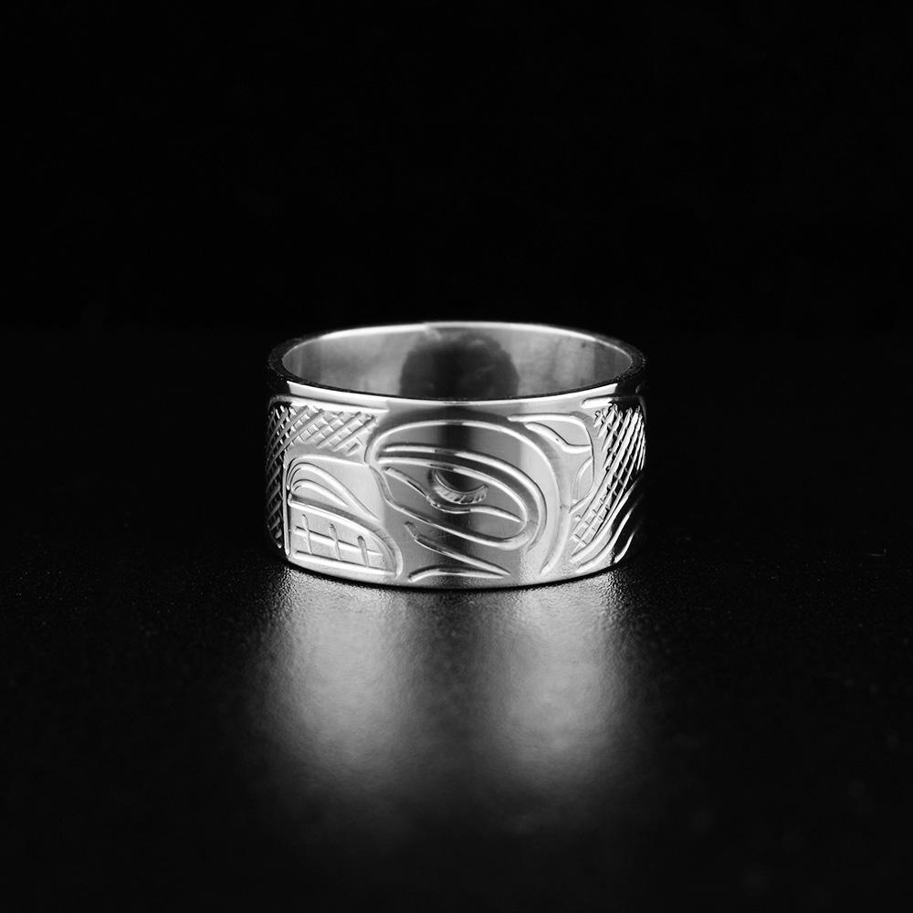 This heavy gauge, wide silver band ring has been made from sterling silver. There is a depiction of the Bear carved into the surface of the band. 