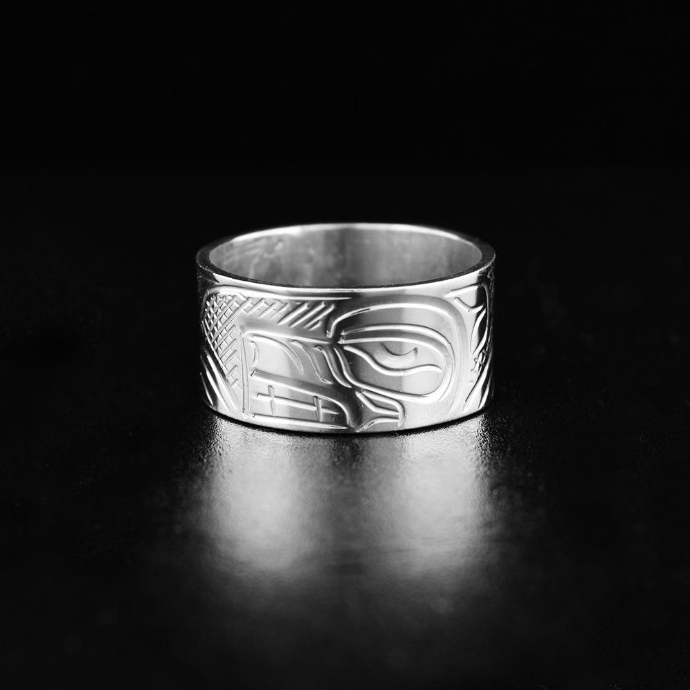 This sterling silver Wolf ring has a wide, heavy gauge band with a depiction of the Wolf carved into the surface of it.