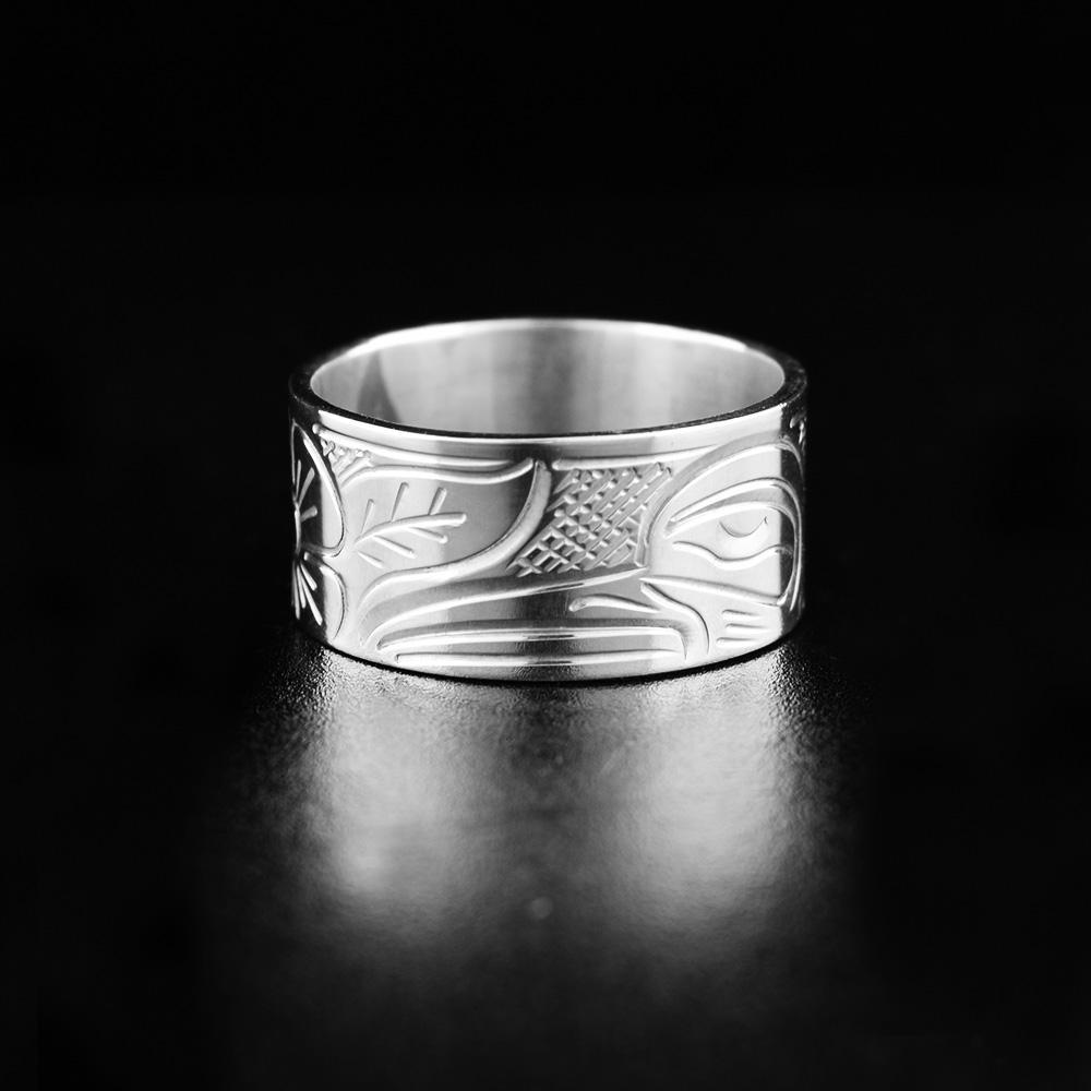 This heavy gauge Hummingbird ring is made from sterling silver and has a wide band. There is a depiction of the Hummingbird carved into the surface of the band.