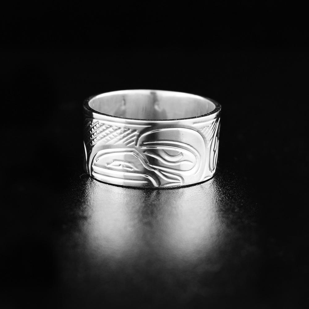 This heavy gauge Raven ring is made from sterling silver and has a wide band. There is a depiction of the Raven carved into the surface of it.