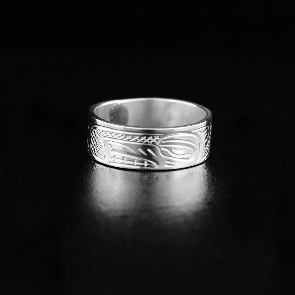 This Wolf ring is made from sterling silver and has a single, heavy gauge band. There is a depiction of the Wolf carved into the surface of the band.