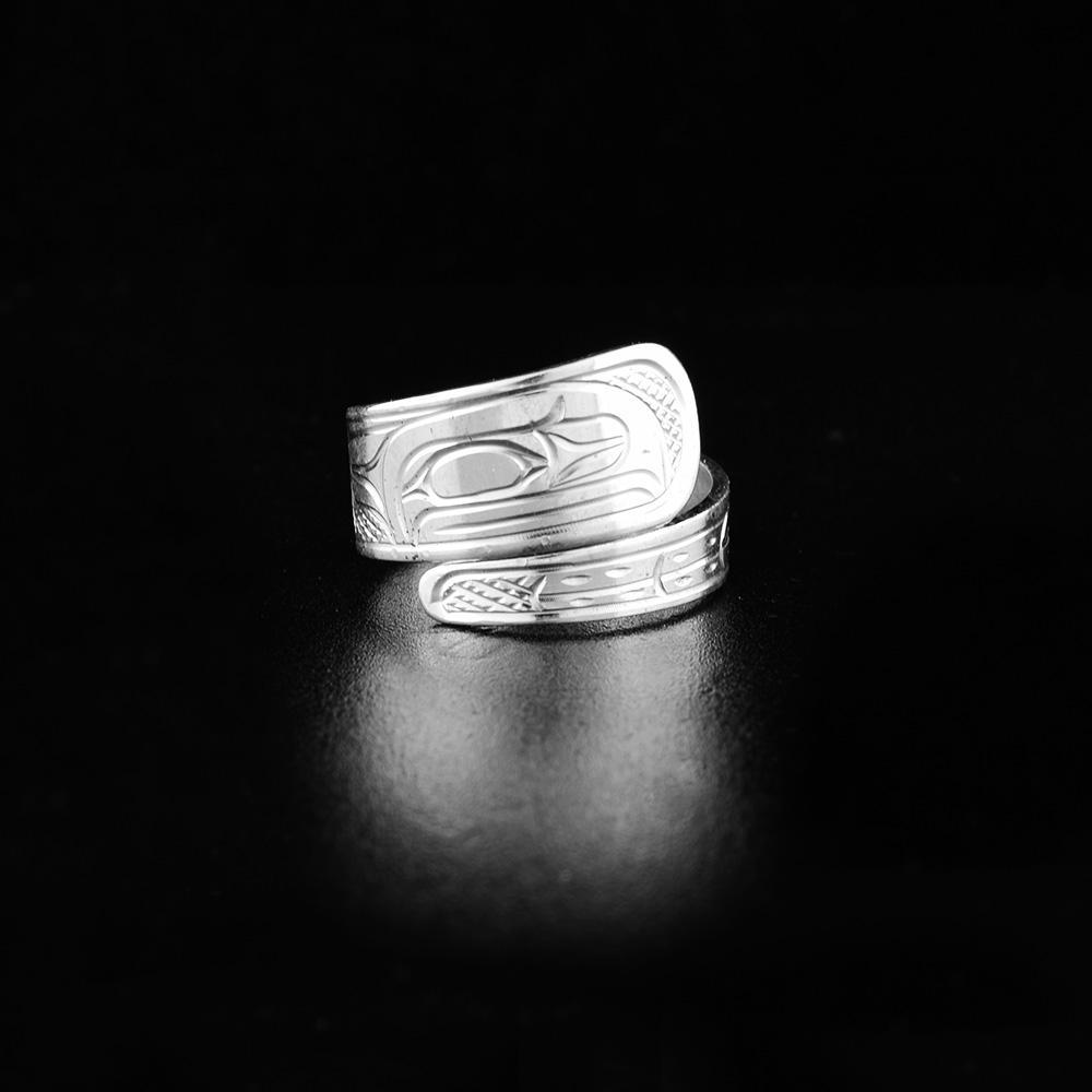 This sterling silver wrap ring has a tapered band that wraps around the finger twice. There is a depiction of the Raven carved into the surface of the band.