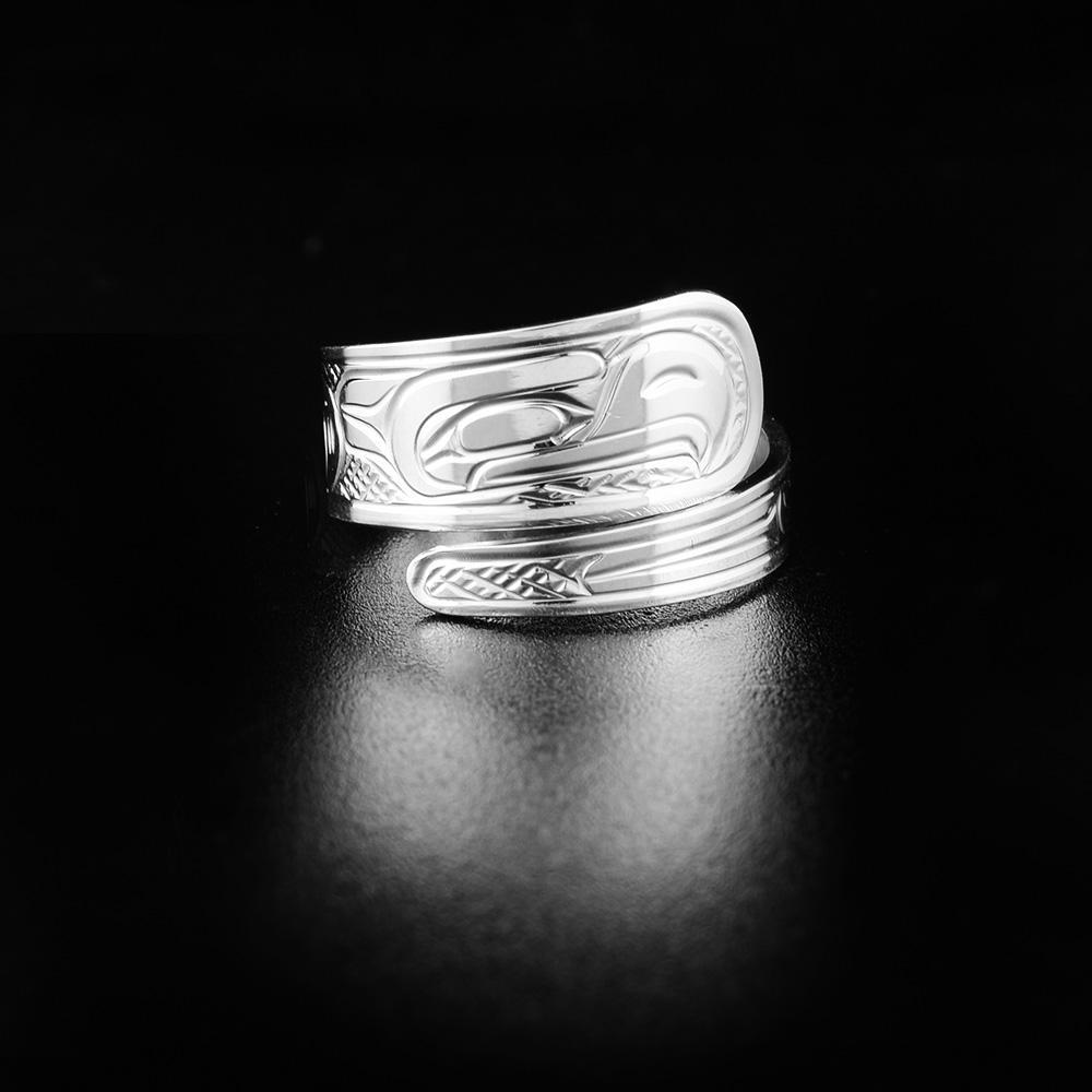 This wrapped Eagle ring is made from sterling silver and it has a tapered band that wraps around the finger twice. There is a depiction of the Eagle carved into the surface of the band.