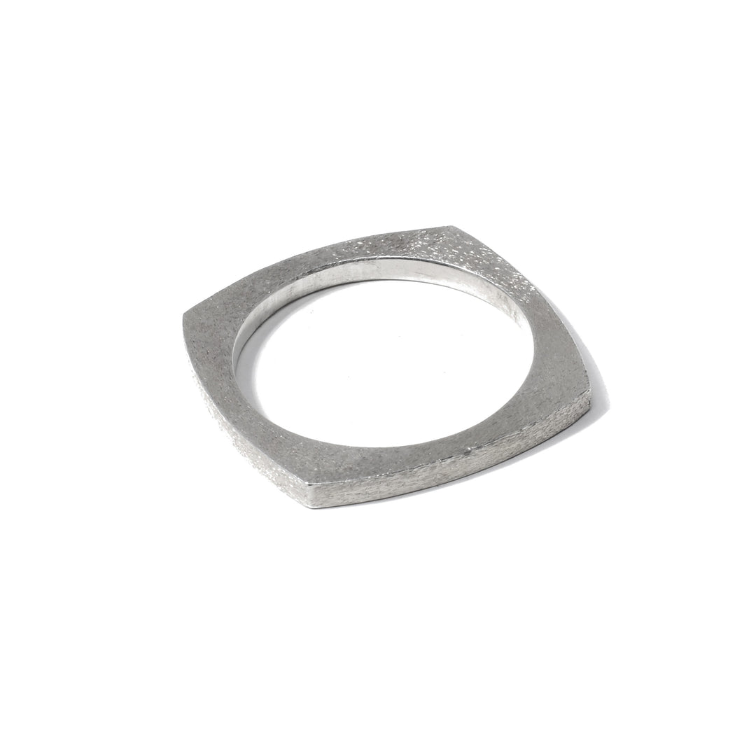 This sterling silver band ring has a thick, but thin square shaped band with a dimpled texture on the surface of it.
