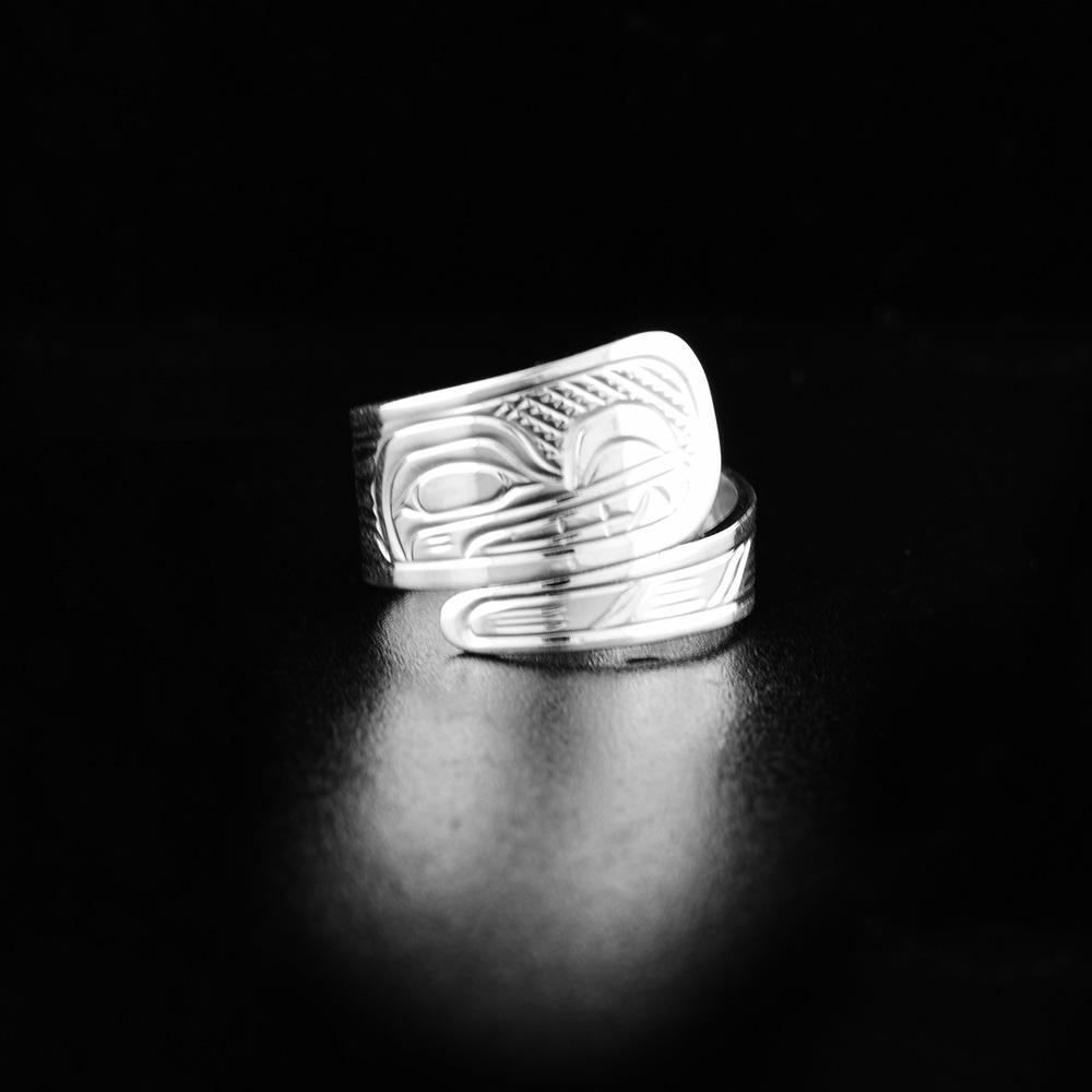 This Wolf ring is made from sterling silver and has a tapered band that wraps around the finger twice. There is a depiction of the Wolf carved into the surface of the band.