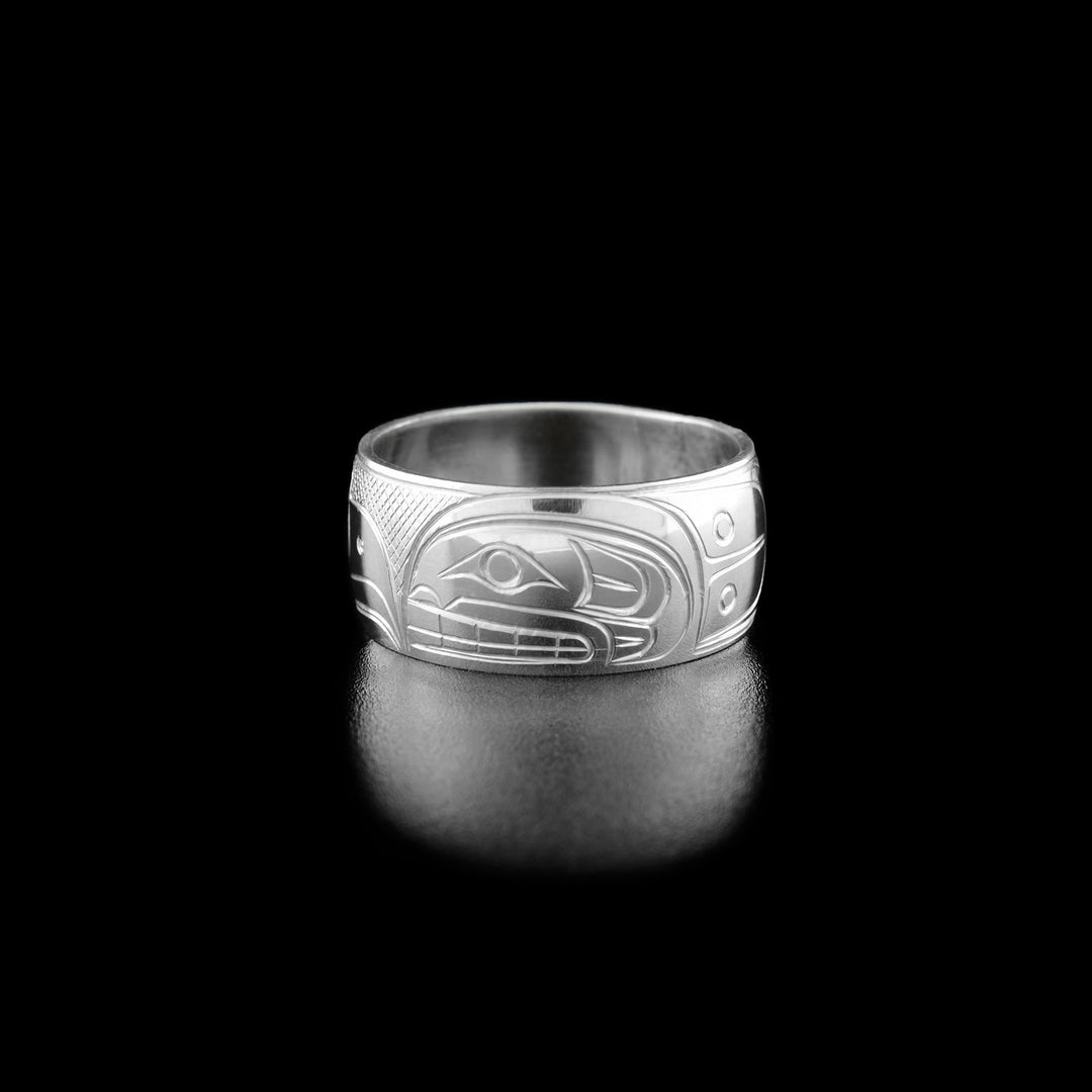Right angle photo of the ring shows carved designs representing the orca's body.