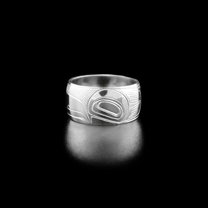 Right angle photo of the ring shows carved designs representing the wing of the raven.